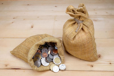 High angle view of coins on wood