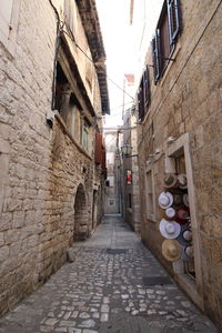 Narrow alley amidst buildings in city