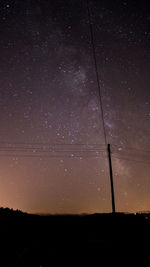 Silhouette trees against sky at night