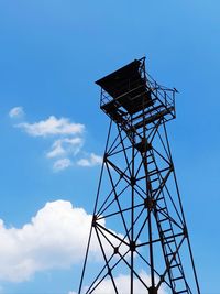 Low angle view of water tower against blue sky