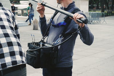 Low section of man standing on street