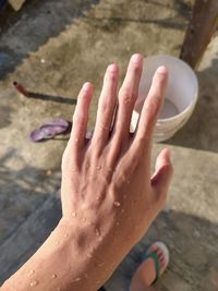 High angle view of woman hand on wet floor