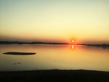 Scenic view of lake against sky during sunset
