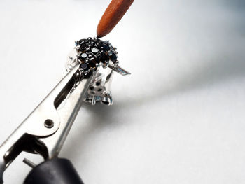 High angle view of cigarette on table against white background