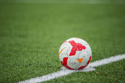 Close-up of soccer ball on field