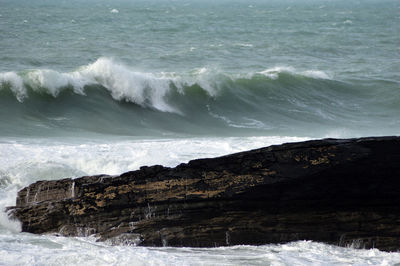 Scenic view of sea against rocks