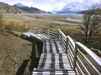 Steps leading towards mountains against sky