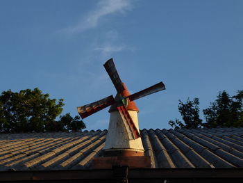 Low angle view of traditional windmill against sky