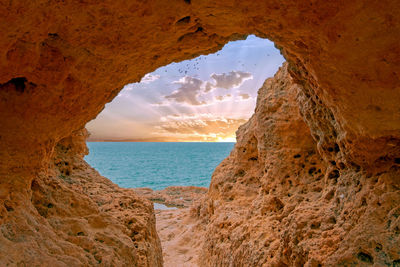 Scenic view of sea seen through cave