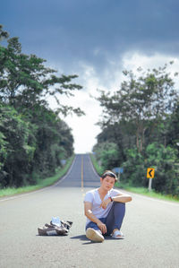 Portrait of woman sitting on road