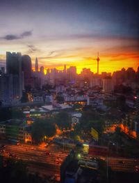 High angle view of illuminated buildings against sky during sunset