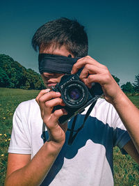 Portrait of man photographing camera