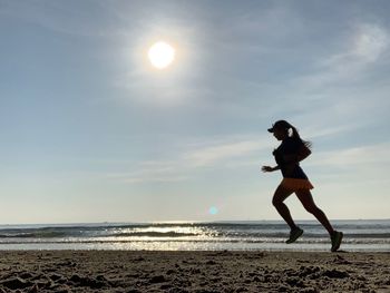 Full length of man on beach against sky