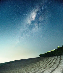 Scenic view of field against clear sky at night