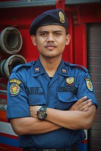 Portrait of smiling man standing in fire truck