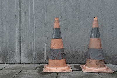 View of traffic cones against wall