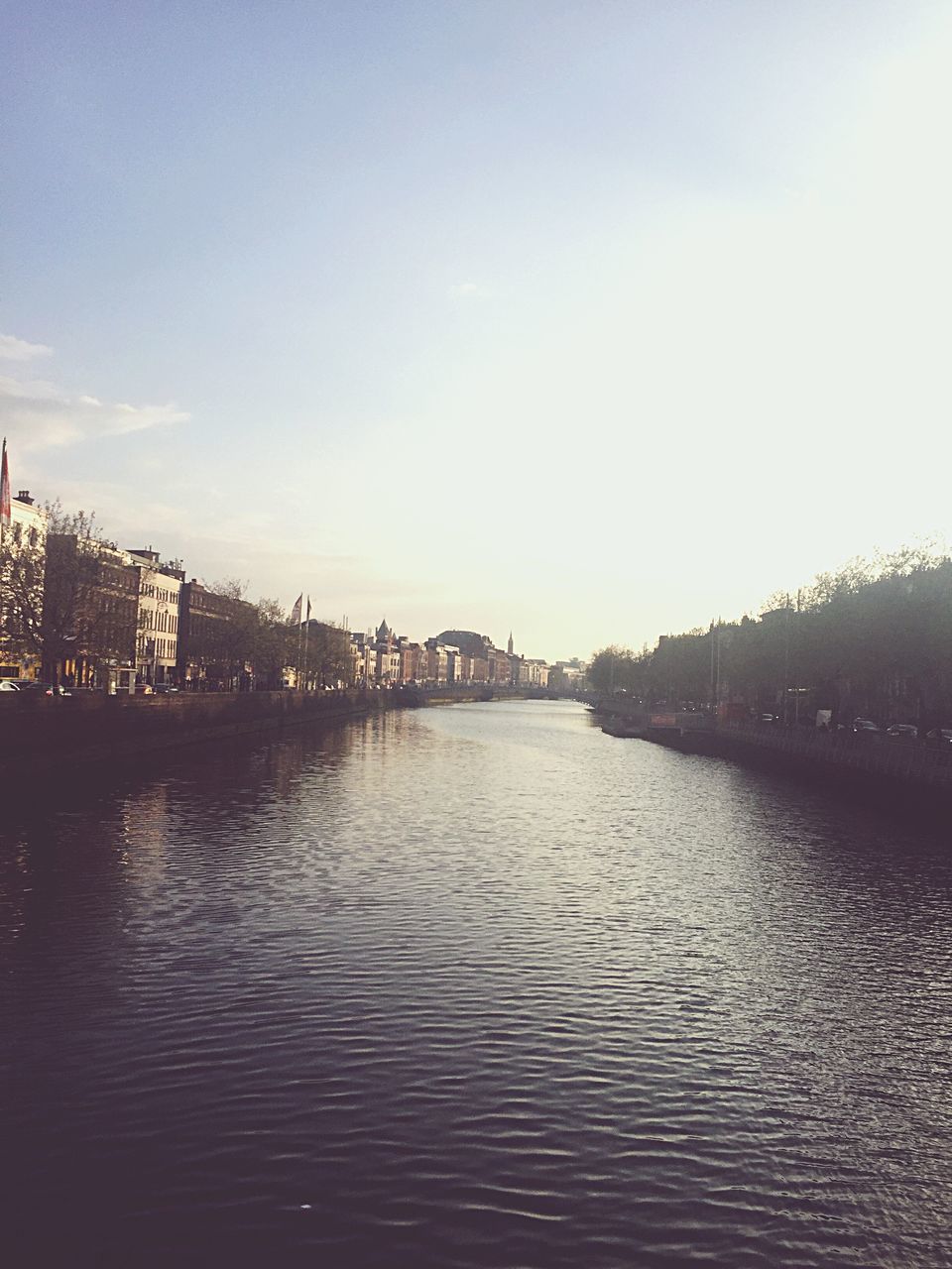 water, waterfront, building exterior, architecture, built structure, river, clear sky, tranquil scene, tranquility, scenics, day, sky, calm, nature, outdoors, no people, beauty in nature, urban skyline, town, remote, city life