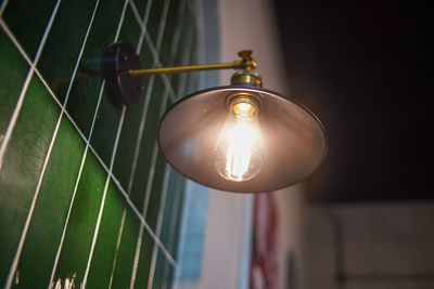 Downlight illuminating the green tiled walls