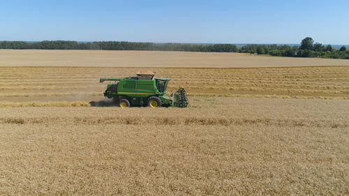 Combine harvester at work harvesting field wheat. combine harvester mows ripe spikelets, barley, rye