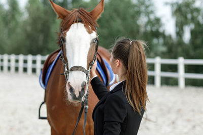 Rear view of woman riding horse