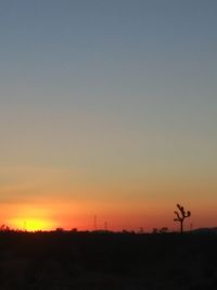 Scenic view of silhouette landscape against clear sky during sunset