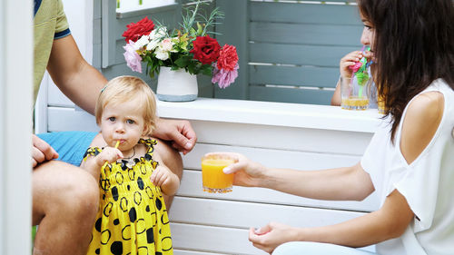 Portrait of girl playing with daughter at home