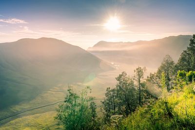 Scenic view of mountains against sky during foggy weather