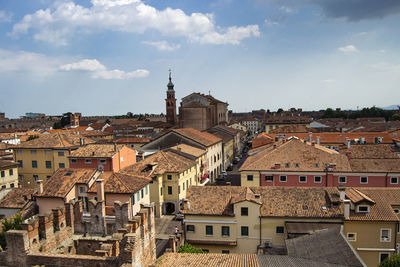 High angle view of buildings in town against sky