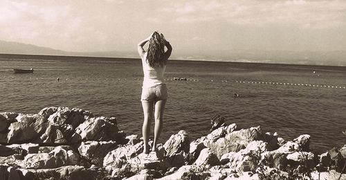 Rear view of man standing on beach