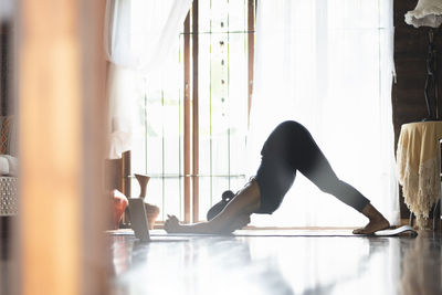 Side view of woman exercising in gym