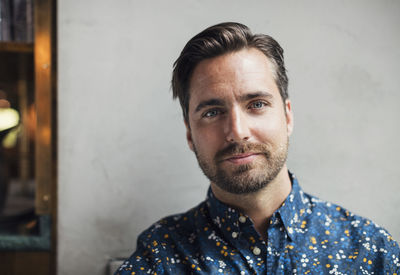 Portrait of confident mid adult businessman at restaurant