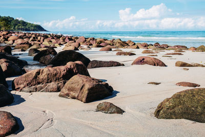 Rocks on beach against sky