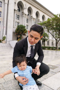 Father and son baby on footpath