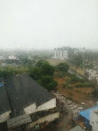 Buildings in city against cloudy sky