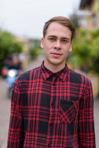 Portrait of young man standing outdoors