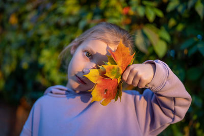 Young woman holding flower