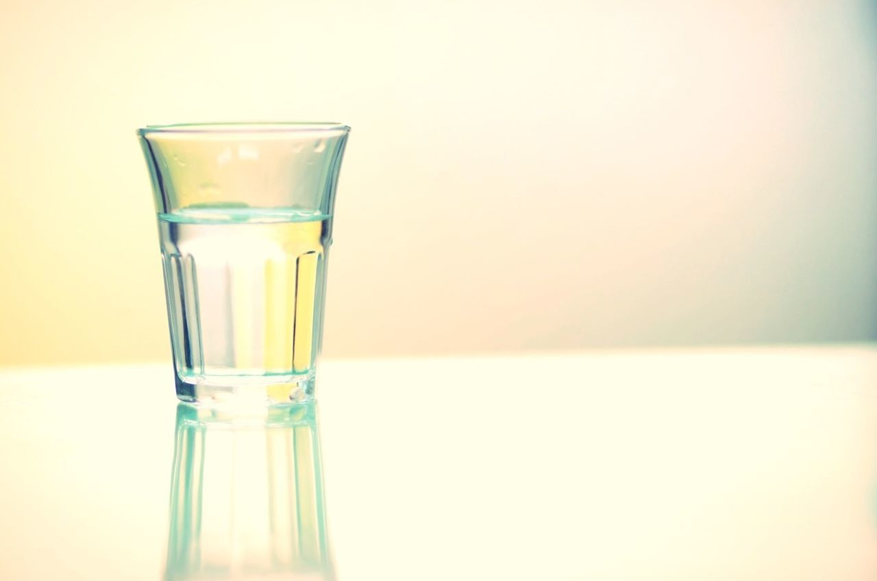 indoors, drink, drinking glass, food and drink, glass - material, still life, refreshment, copy space, white background, table, transparent, close-up, studio shot, freshness, glass, alcohol, no people, liquid, focus on foreground, bottle