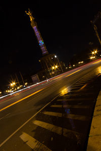 Light trails on road in city at night