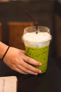 Cropped image of hand holding drink