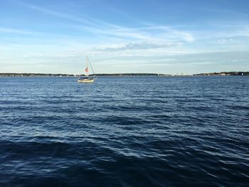 Sailboat in sea against sky