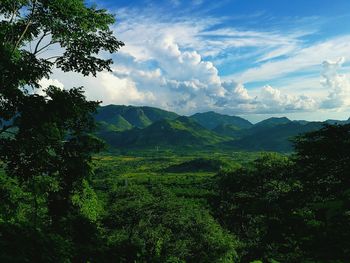 Scenic view of green landscape against sky