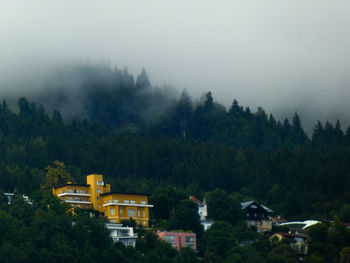 Buildings on mountain against sky