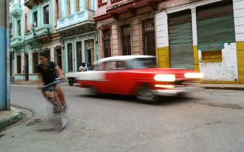 Blurred motion of people walking on road