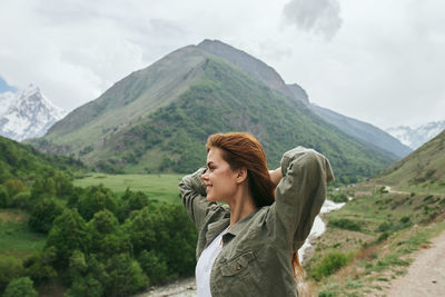 Side view of woman looking at mountains