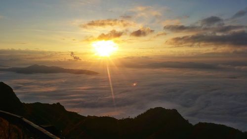 Scenic view of silhouette mountains against sky during sunset