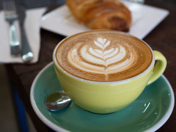 Close-up of coffee cup on table