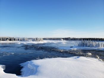 Scenic view of frozen lake against clear sky