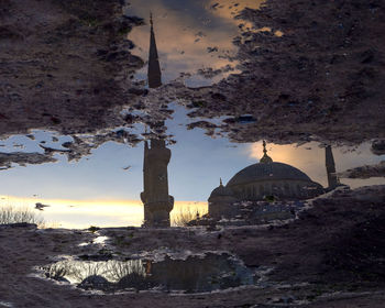 Upside down image of sultan ahmed mosque reflection in puddle