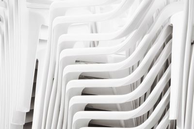 High angle view of plastic chairs folded into each other