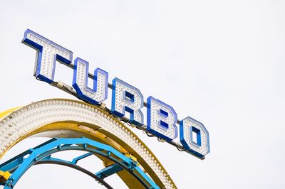 Low angle view of sign board against clear sky